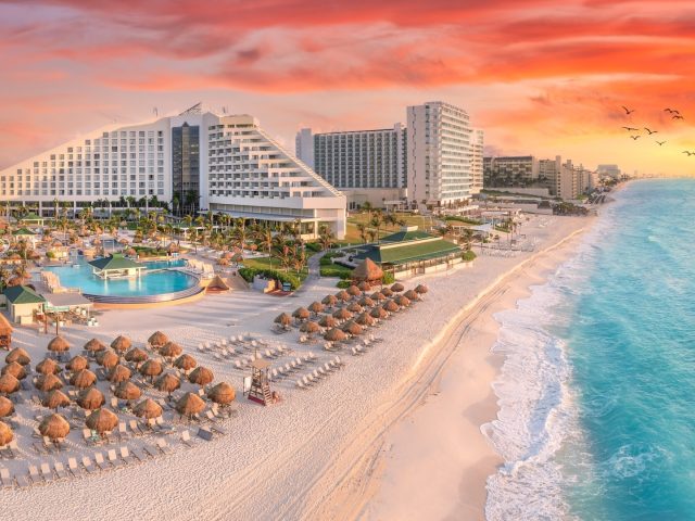 Cancun beach with resorts near blue ocean